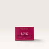 House of Holabox Wild Emery Love shower steamer in a deep pink box with rose geranium and juniper berry scent.
