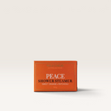 House of Holabox Wild Emery Peace shower steamer in an orange box with sweet orange and patchouli scent