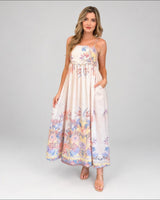 House of Holabox Sara Spring Maxi Dress in yellow floral print cotton with ruching and pockets on a model