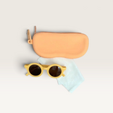 House of Holabox Little Drop yellow kids sunglasses with UV400 acrylic lenses, silicone zip case, and cleaning cloth.
