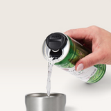 Green slim aluminium can with a black lid pouring liquid into a stainless steel cup held by a hand, Huski Slim Can Cooler features visible on lid