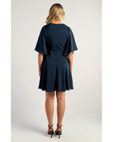 Back view of a navy Belle Wrap Dress featuring elegant bell sleeves and a layered frill hem.