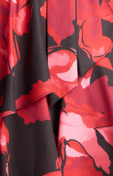 Faith Floral Mini Dress in a bold red and black floral print featuring a layered ruffle hem detail.
