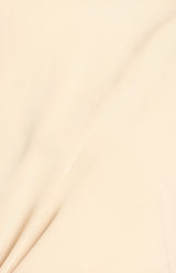Close-up of the cream-coloured satin fabric used for the Saddie Batwing Sleeve Top, showing its smooth, draped texture.