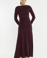 Deep plum long-sleeve jersey dress with a boat neckline, gathered waist, and flattering seam details.