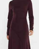 Deep burgundy long-sleeve jersey dress with a boat neckline, gathered waist, and flattering seam details.