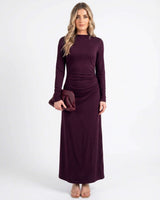 Plum jersey midi dress with boat neckline, long sleeves, and gathered waist detail on a model.