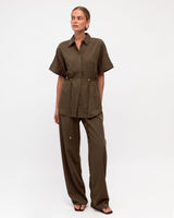 Olive green cotton-blend drawstring pants paired with a matching short-sleeve tie-waist shirt.