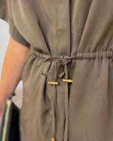 Olive green drawstring shirt in cotton-nylon blend featuring a cinched waist with gold-toned metal cord ends.