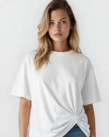 Woman wearing a crisp white cotton-blend Jen Tee with a stylish side-knot detail.