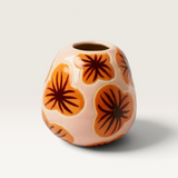 House of Holabox Jones & Co Pollen ceramic bud vase in pale pink with retro orange and brown floral patterns.