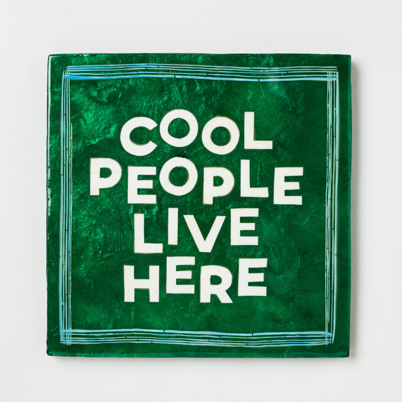 Green square sign with 'Cool People Live Here' text on a white background