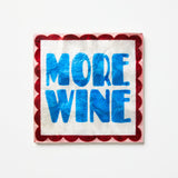 Napkin with 'More Wine' text on a white background