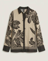 June Collared Shirt in beige and black floral print with a classic collar, button-down front, and contrast trim.