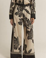 High-rise wide-leg June pants in a beige and black floral print with double pleat detailing.