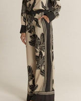 High-rise wide-leg June pants in a beige and black floral print with double pleat detailing.