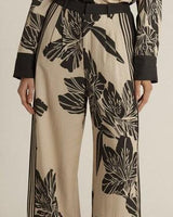 High-rise wide-leg June pants in a beige and black floral print with double pleat detailing and a relaxed tailored fit.