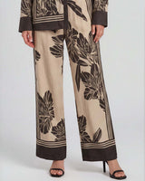 High-rise, wide-leg June pants in a beige and brown floral print with double pleat detailing.