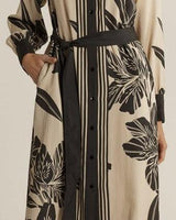 June midi shirt dress in cream and black floral print with a belted waist, button-down front, and side pockets.