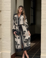 June Shirt Dress in a cream and black floral print with a classic collar, contrast trim, and a relaxed midi silhouette.