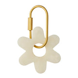 White Kip resin flower key ring with a high-gloss finish and a brass-look D-lock clasp.