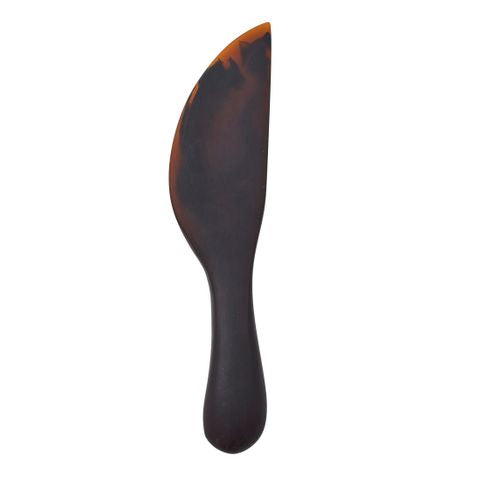 Black and orange spatula on a white background