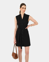 Black sleeveless cotton utility dress with a mandarin collar, button front, belted waist, and two front patch pockets.