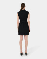 Back view of a black sleeveless cotton utility dress with a mandarin collar and belted waist.