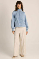 Light blue washed denim bubble jacket with a stand collar, snap buttons, and subtle puff sleeves.