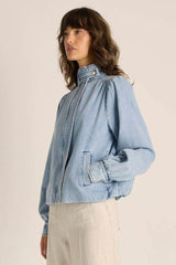 Light blue soft washed denim bubble jacket with a stand collar, snap closures, and subtle puff sleeves.