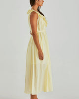 Light yellow cotton midi sun dress featuring a ruffled neckline, sleeveless cut, and a self-tie waist belt.