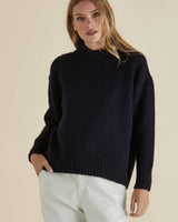 Navy blue mock neck knit jumper with ribbed cuffs and hem, featuring a relaxed fit and soft stretch texture.
