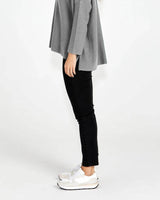 Luella black stretch jeans with a slim fit, mock pockets, and cotton-blend fabric paired with white sneakers.