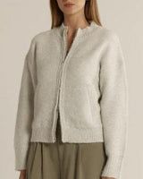 Lumi zip-up jumper in snow marle white, featuring a soft fluffy knit, ribbed trims, and a double zip-through front.