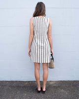 Back view of a sleeveless Luna shift dress in cream with vertical black stripes, featuring a relaxed cotton blend fit.