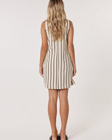 Back view of a sleeveless, cream-colored cotton-blend shift dress featuring vertical black stripes.