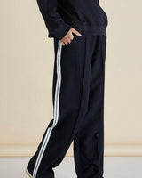 Black Maddison joggers with a relaxed fit, side pockets, and white stripe detailing down the leg.