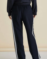 Black Maddison joggers with a relaxed fit, elasticated waistband, and white side-stripe detailing on the legs.