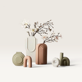 House of Holabox magnolia bud spray in a modern ceramic vase surrounded by various minimalist decorative vases