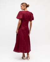 Burgundy pure linen Mazie event dress featuring romantic puff sleeves and a midi-length silhouette.