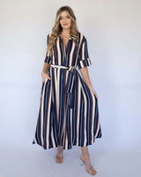 Midnight Morsel midi dress with a navy, cream, and burgundy vertical stripe pattern, collar, and waist tie belt.
