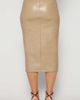 Back view of a latte-colored vegan leather midi skirt with a center seam, worn with black strappy heels.