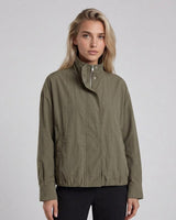 Olive green Murphy bomber jacket with a zip front, silver snap details, and an elasticated hem on a model.
