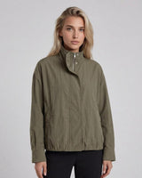 Olive green Murphy bomber jacket with a zip front, silver snap details, and an elasticated hem on a model.