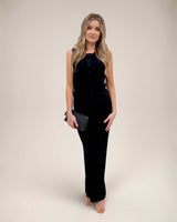Woman wearing black Nash knit pants with an elasticated waistband and matching button-up knit top.