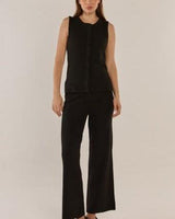 Model wearing black Nash knit pants with an elasticated waistband and relaxed fit, paired with a matching knit top.
