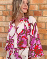 Novara linen-blend dress with a pink and red floral print, button-through front, and removable waist tie.
