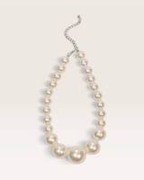 House of Holabox Becoming Pearl Necklace featuring graduated faux pearls on cotton thread with a silver-tone extender.