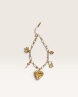 House of Holabox gold charm bracelet featuring heart locket, key, bow, and lock pendants on a polished chain.