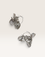 House of Holabox silver sculptural floral hoop earrings with a polished, lightweight metal finish.